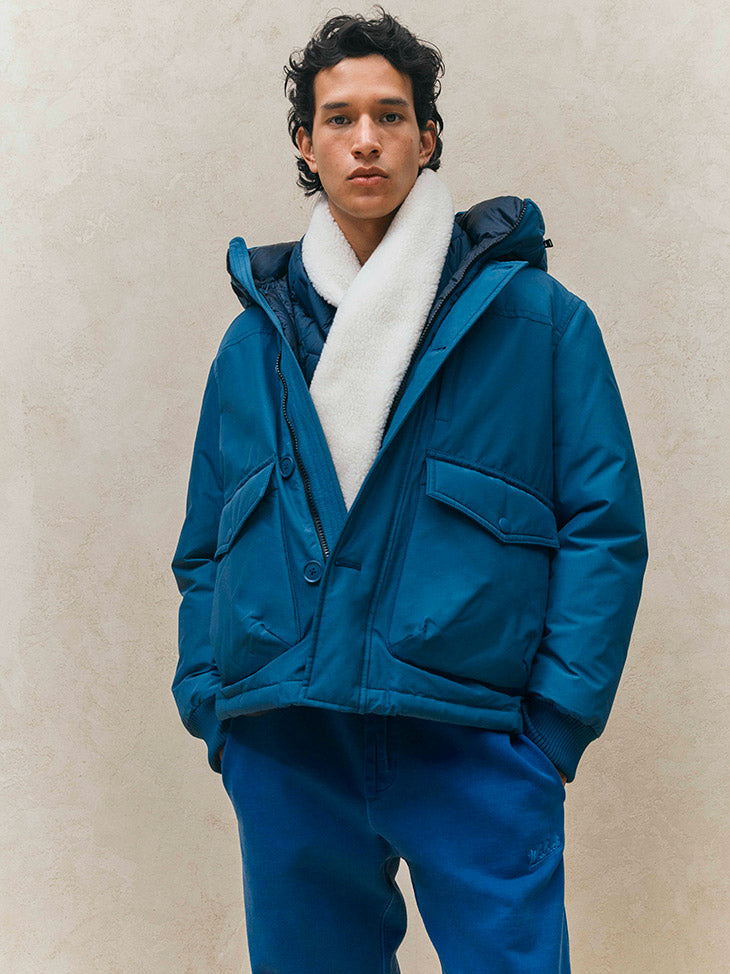 Luxury men's outerwear featuring a stylish insulated jacket with a faux shearling collar