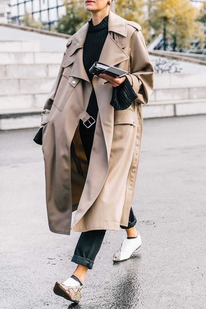 Stylish outdoor shot of a model wearing a designer women's jackets over chic attire