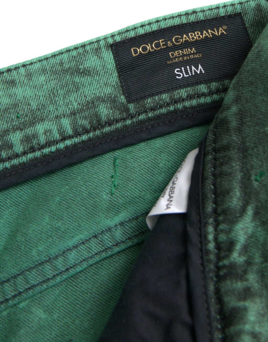 Dolce &amp; Gabbana – Eng anliegende Jeans aus Baumwollstretch mit grünen Kristallen