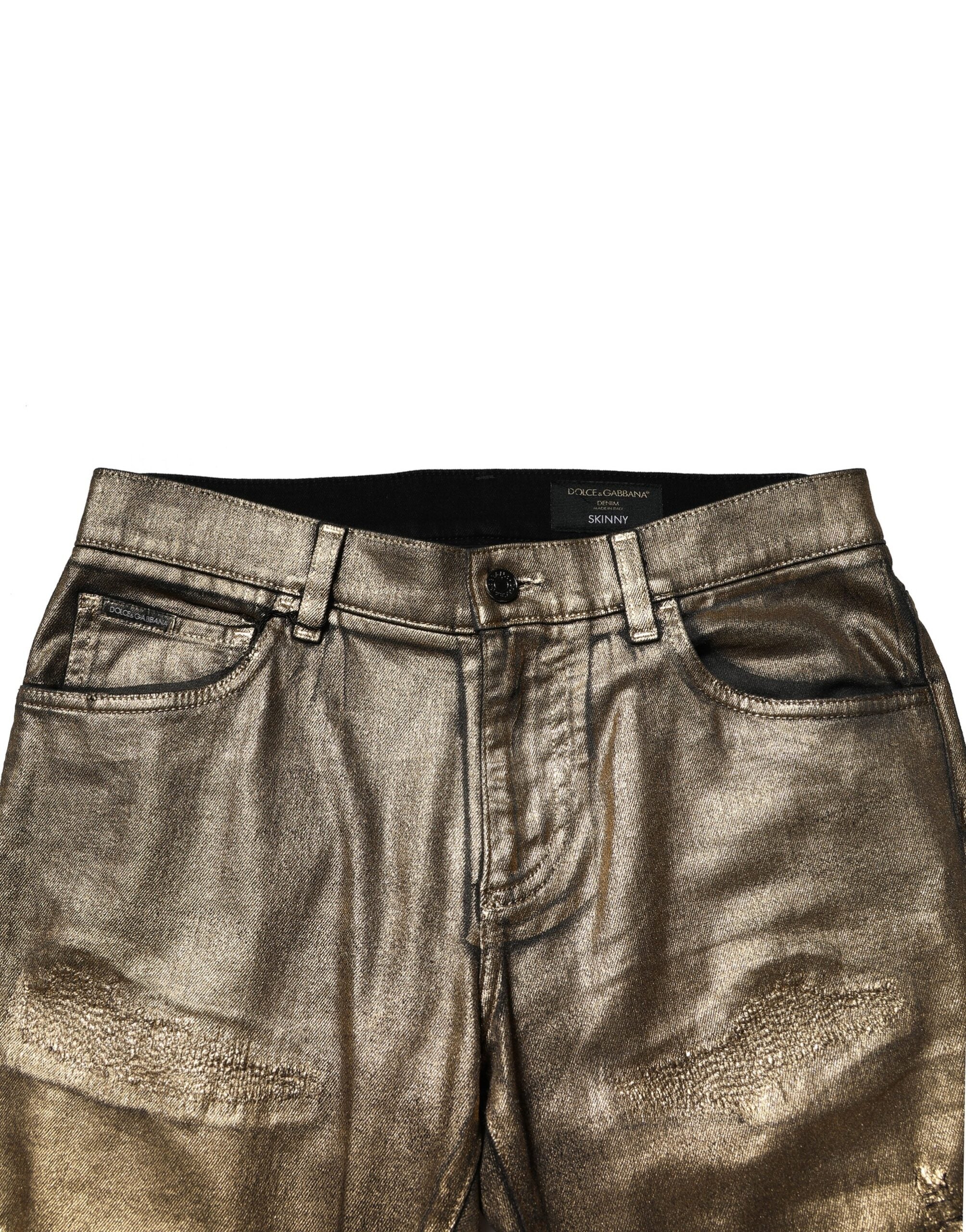 Dolce &amp; Gabbana – Schmal geschnittene Jeans aus zerfetzter Baumwolle mit Stretchanteil in Gold