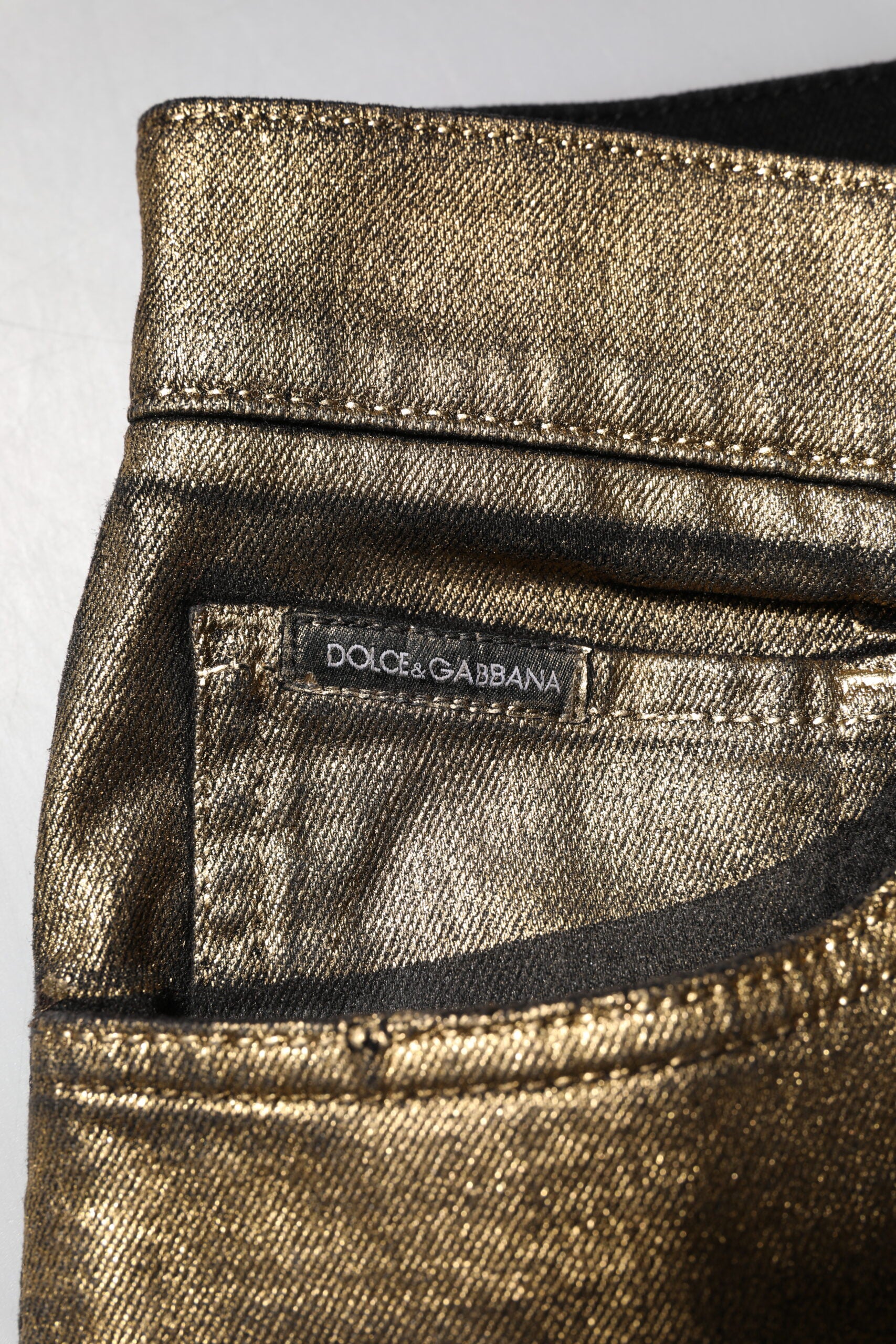 Dolce &amp; Gabbana – Schmal geschnittene Jeans aus zerfetzter Baumwolle mit Stretchanteil in Gold