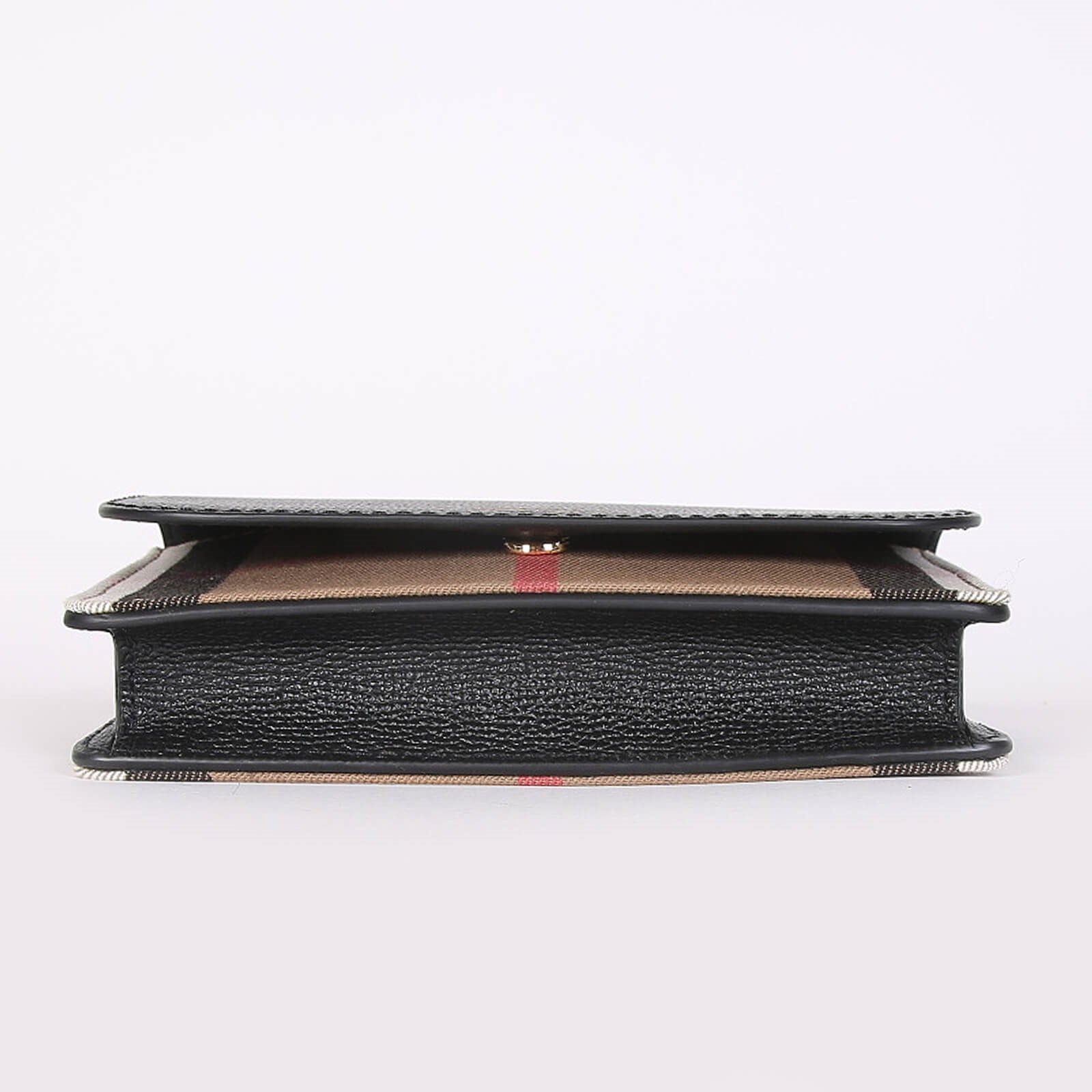 Side view of Burberry crossbody bag black with signature check pattern and black leather trim