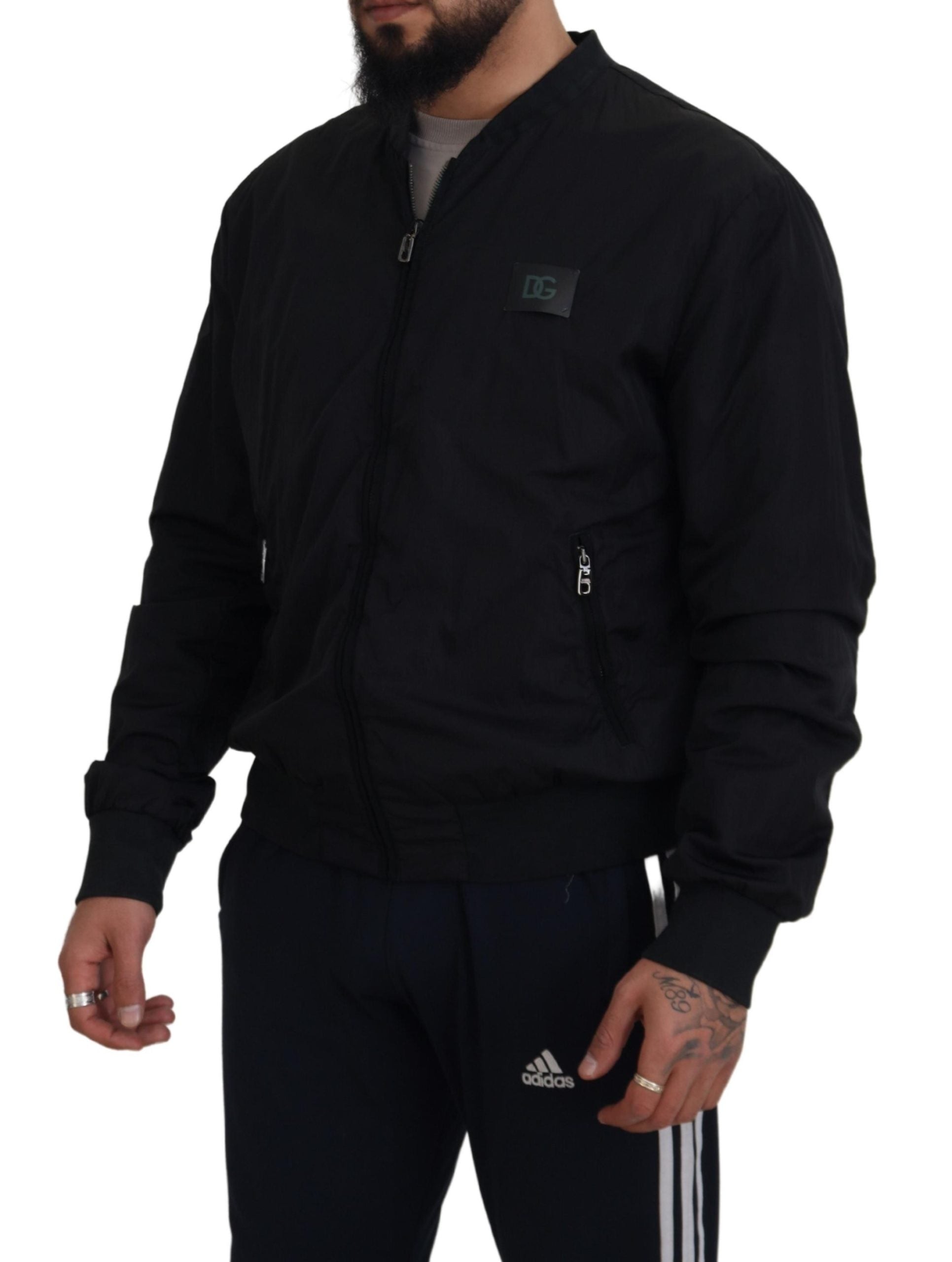 Dolce & Gabbana black bomber jacket with zip front and logo patch on chest worn by male model