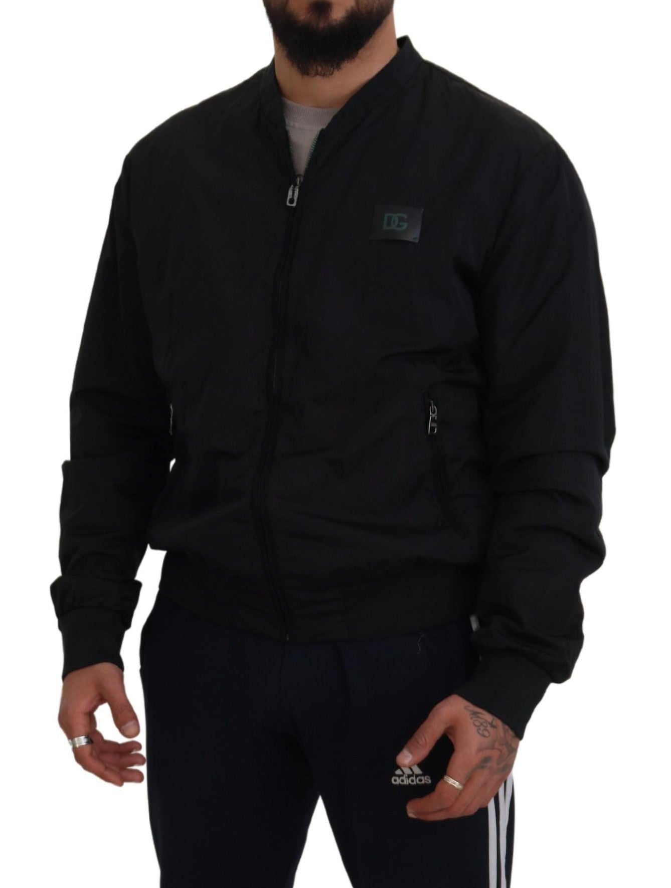 Dolce & Gabbana black bomber jacket worn by man with front zipper and logo patch on chest