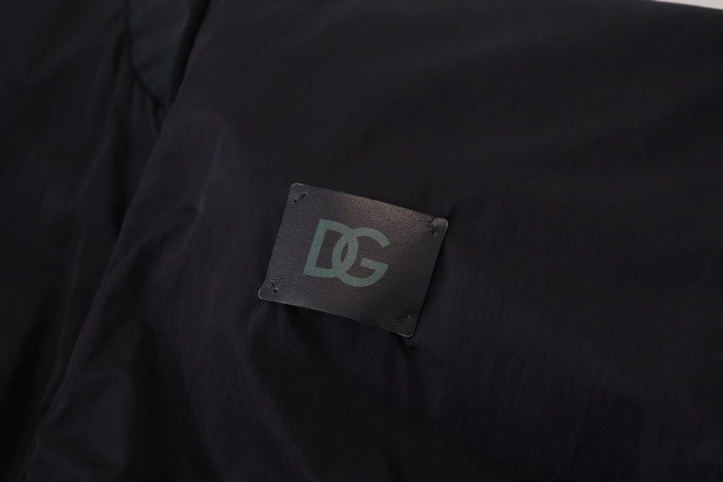 Close-up of Dolce & Gabbana black bomber jacket featuring DG logo patch on fabric