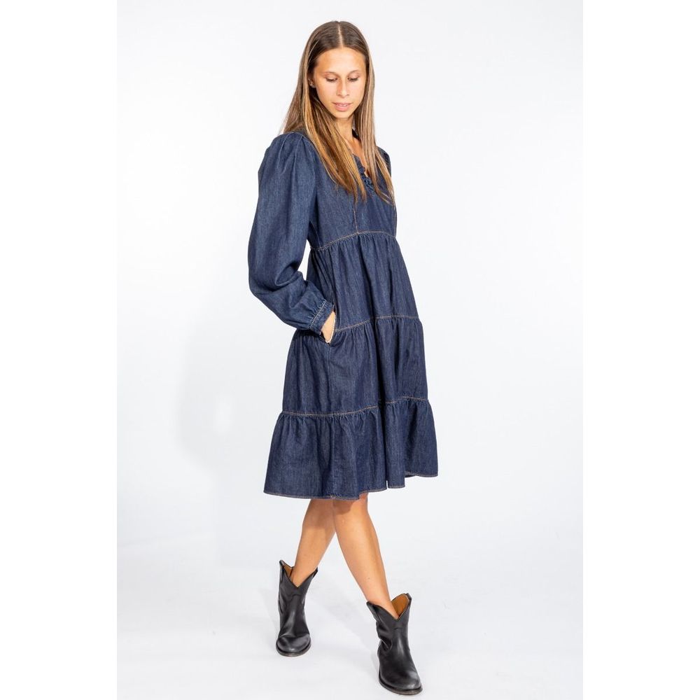 Love Moschino denim dress with long puff sleeves and tiered skirt worn with black ankle boots